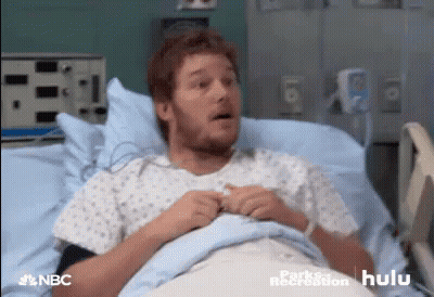 Surgeon In Mask And Gloves Looking At Camera GIF