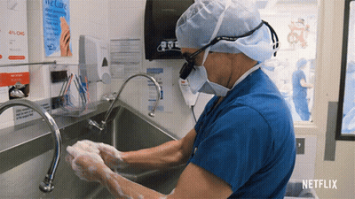 Surgeon Washing Hands In Front Of Netflix Sign GIF