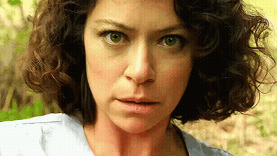 Surprised Curly-Haired Woman Looking At Camera GIF
