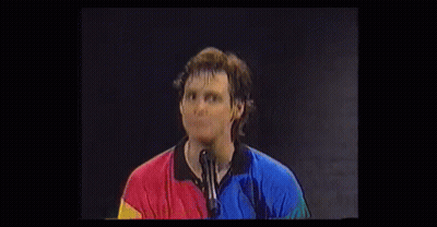 Surprised Man In Colorful Shirt With Hands GIF