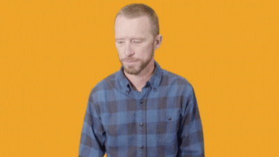 Surprised Man In Plaid Shirt Hands In Air GIF