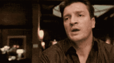 Surprised Man Sitting At Table GIF