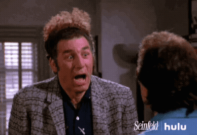 Surprised Man Talking To Woman In Seinfeld Hulu Ad GIF