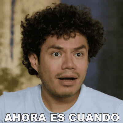Surprised Man With Curly Hair Saying Ahora Es Cuando GIF
