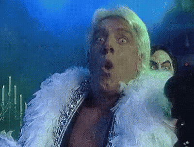 Surprised Man With Feather Boa GIF