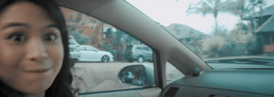 Surprised Woman In Car Looking Out Window GIF