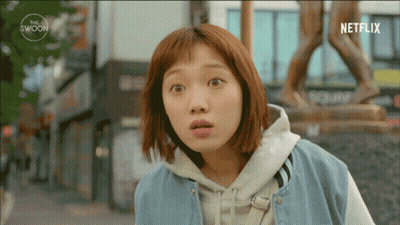 Surprised Woman In Front Of Statue And Netflix Logo GIF