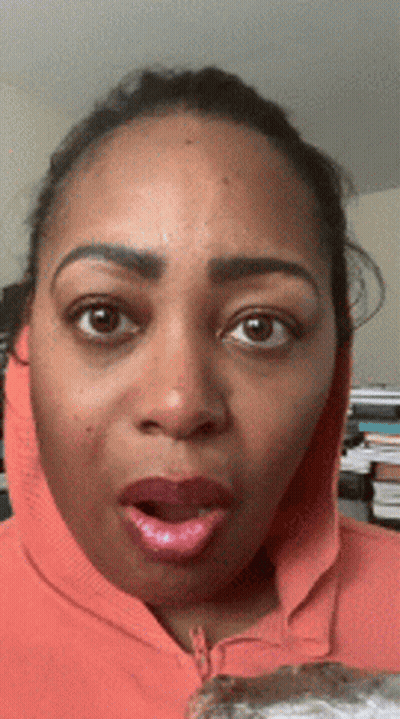 Surprised Woman In Orange Hoodie GIF