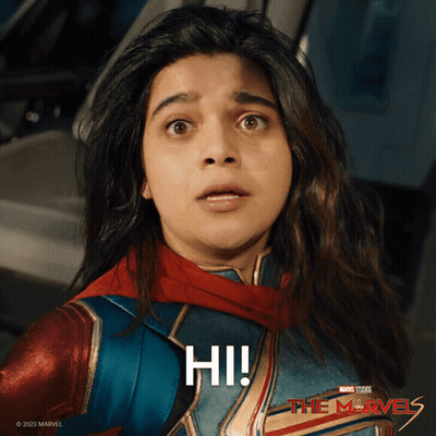 Surprised Woman In Superhero Costume Saying Hi GIF