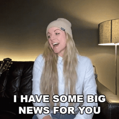 Surprised Woman On Couch Saying Big News GIF