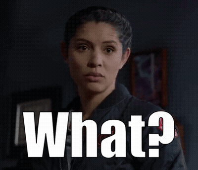 Surprised Woman Standing Before What Sign GIF