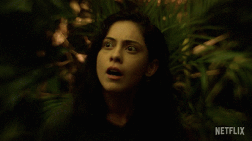 Surprised Woman Surrounded By Greenery And Netflix Logo GIF