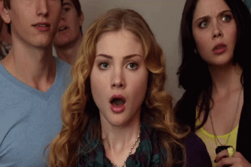 Surprised Woman Surrounded By People GIF