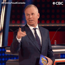 Survey Says Gerry Dee Pointing At Board GIF