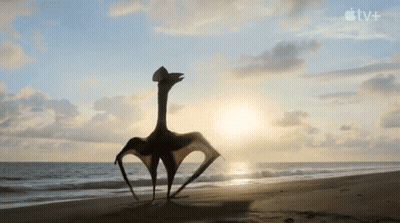 T-Rex And Baby T-Rex On Sandy Beach With Apple TV+ Logo GIF