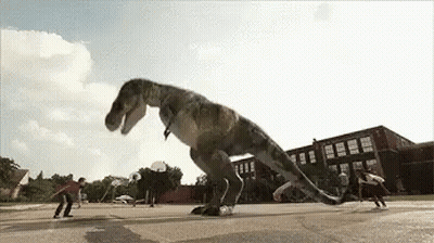 T-Rex Jumping Over Skateboarders In Parking Lot GIF