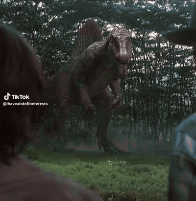 T-Rex Statue Standing In Grass GIF