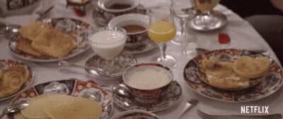 Table With Food Drinks And Netflix Logo GIF