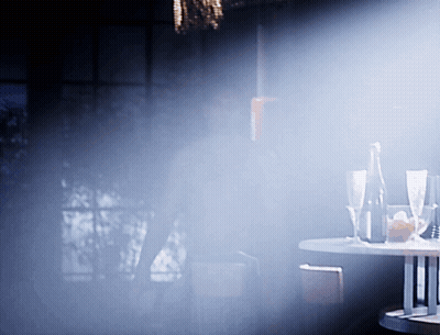 Table With Glasses And Bottle In Dark Room GIF