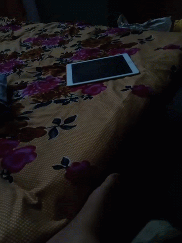 Tablet Laying On Floral Bed GIF