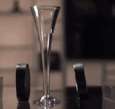 Tall Glass Beside Black Tape GIF