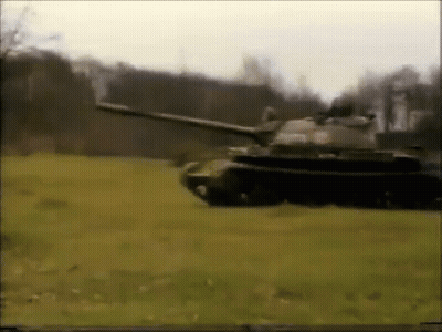 Tank Driving Through Field With Trees GIF