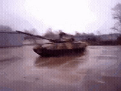 Tank Driving Through Flooded Parking Lot GIF