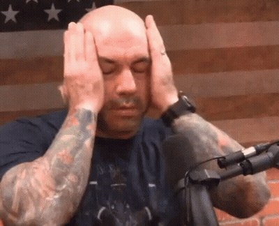 Tattooed Man Covering Head At Microphone GIF