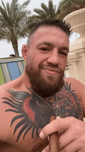 Tattooed Man Holding Cigar GIF