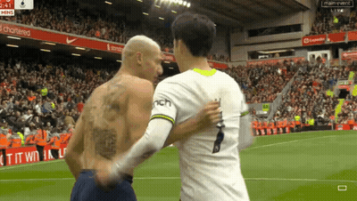 Tattooed Man Shaking Hands On Soccer Field GIF