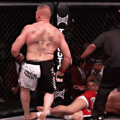 Tattooed Man Standing Before Punching Bag GIF