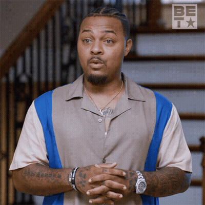 Tattooed Man Standing In Front Of Stairs With Be Icon GIF