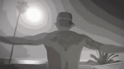 Tattooed Man Standing With Arms Out GIF