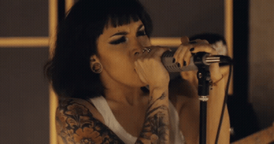 Tattooed Woman Singing Into Microphone GIF