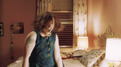 Tattooed Woman Standing On Bed GIF