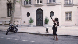 Taxi Driving Past Woman In Dress GIF