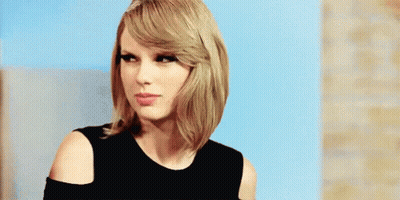 Taylor Swift In Black Off-Shoulder Top Looking At Camera GIF