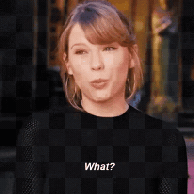 Taylor Swift In Black Sweater Making Funny Face GIF