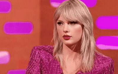 Taylor Swift In Pink Dress Making Funny Face On Stage GIF