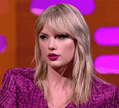 Taylor Swift In Purple Sequined Jacket And Lipstick GIF
