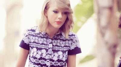 Taylor Swift In Purple White Floral Shirt With Man GIF