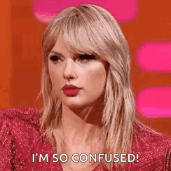 Taylor Swift Is Wearing A Red Dress And Making A Funny Face . GIF