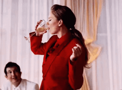 Taylor Swift Next To Man In Purple White Floral Shirt GIF