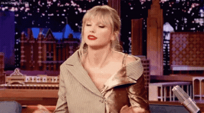 Taylor Swift Sitting At Microphone On Stage GIF