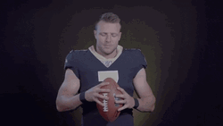 Taysom Hill Extending Hand Holding Football Forward GIF