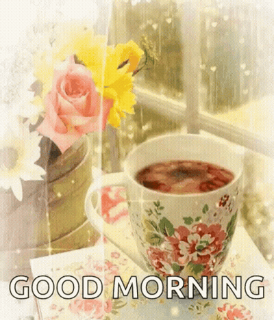 Tea Cup And Vase Of Flowers Near Window GIF