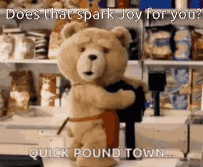 Teddy Bear In Apron Holding Black Shirt GIF