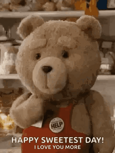 Teddy Bear In Red Apron Holding Box Says Happy Sweetest Day GIF
