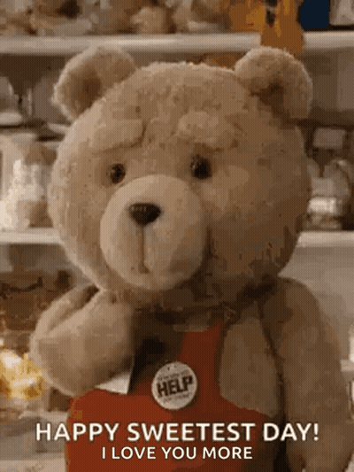 Teddy Bear In Red Apron With Help Button Holding Box GIF
