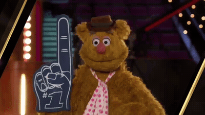 Teddy Bear In Tie And Hat Holding Foam Finger GIF
